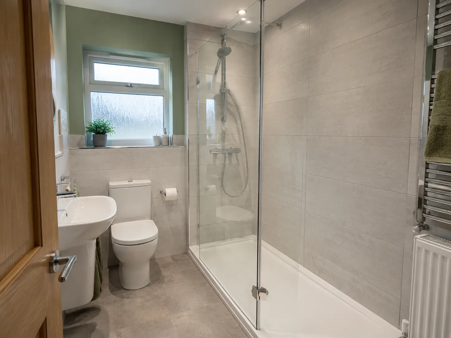 Low-profile shower fitted in the former bath space of a British bathroom
