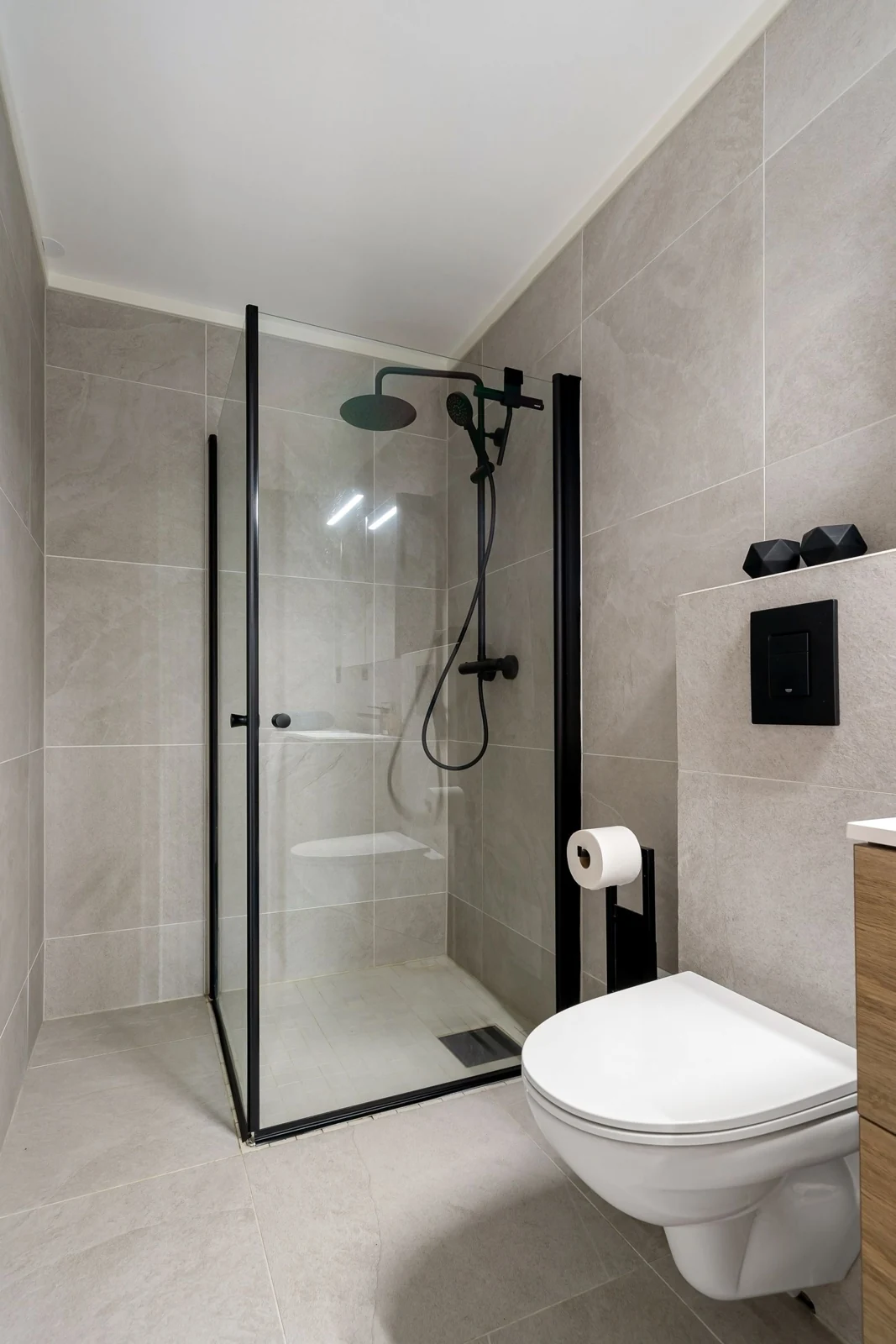 Sleek modern bathroom featuring a frameless glass shower and minimalist design